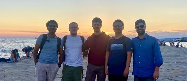 Group members at sunset by the sea