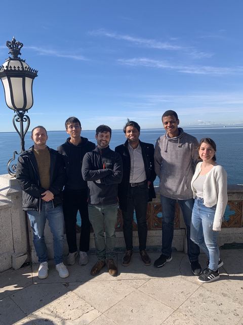 Group members on a terrace overlooking the sea