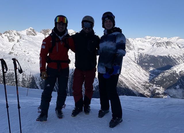 Three skiers on a snowy mountain