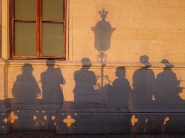 Shadows of the group on a sunlit wall